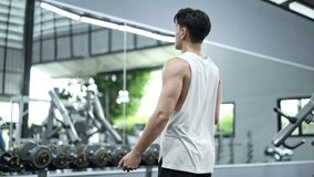 Muscular young athlete warming up, stretching upper body muscles before intensive training session in well equipped fitness center - Powered by Shutterstock - Get 15% off with code: PIKWIZARD15
