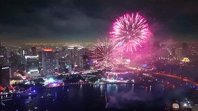 Explosive bursts captured in sweeping detail as fireworks arc and bloom over the bay from a high-flying drone perspective. - Powered by Shutterstock - Get 15% off with code: PIKWIZARD15