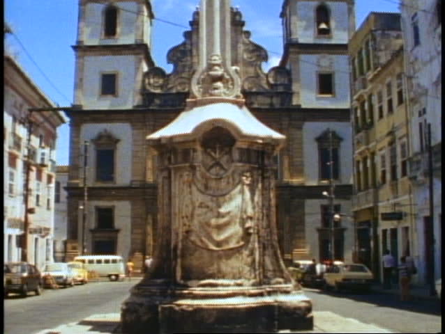 Salvador, Brazil, giant cross in foreground, church, tilt up, medium wide shot