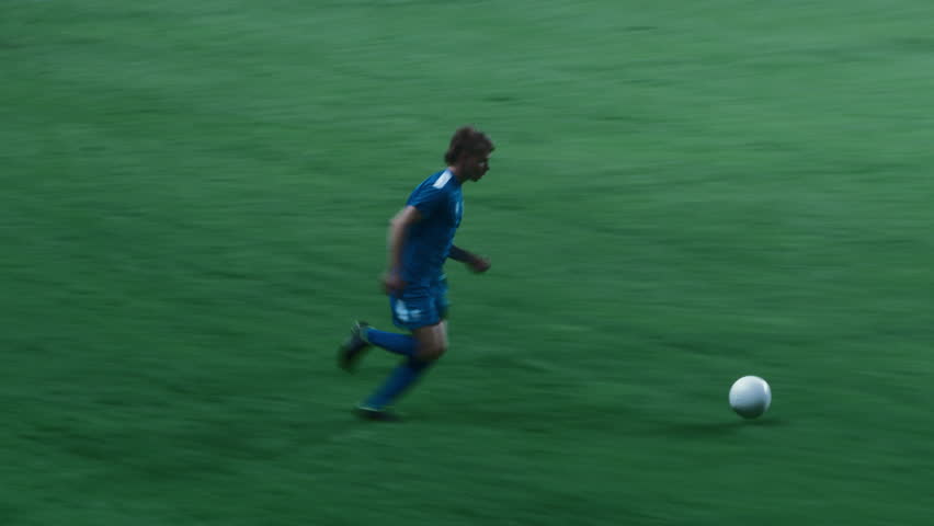 Soccer Championship: Caucasian Blue Team Football Player Attacks and Scores a Goal, Winning Major League Match. Sport Channel Broadcast Television Playback Template. Close Up Tracking Shot