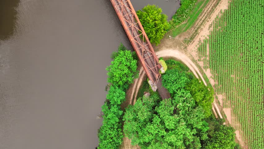 Eiffel-designed bridge in Causses du Quercy, France, arches over rugged terrain, blending industrial elegance with natural beauty in a UNESCO heritage landscape