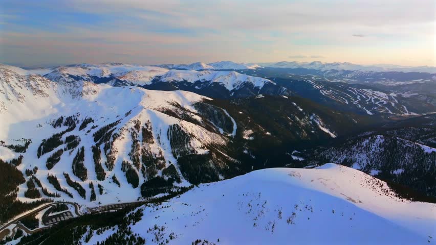 Spring winter sunset golden hour Summit County Abasin Breckenridge Keystone ski resort aerial drone Colorado Rocky Mountains Continental Divide ski snowboard trail runs circle left motion