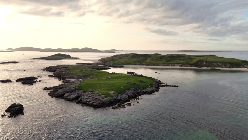Tiny cottage on an Island off the coastline of Ireland just before sunset.