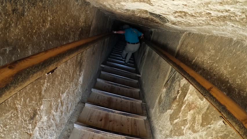 POV: Tourist descends small, steep passage ramp into Egyptian tomb