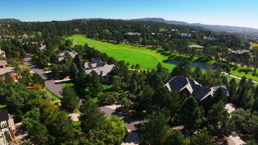 Castle Pines Village North Ridge Golf Course spring summer aerial drone Denver Colorado front range sunrise morning i25 Highlands Ranch Park Meadows Daniels Park homes green grass forward pan up