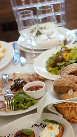 Catering service on banquet table with canape snacks in restaurant or hotel. Decorated food set on birthday, wedding celebration or business conference event venue