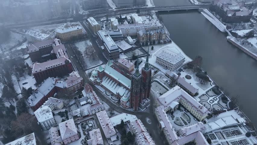 A winter aerial view the Wroclaw Cathedral (Katedra sw. Jana Chrzciciela) and the nearby snow-covered buildings in Wroclaw, Poland