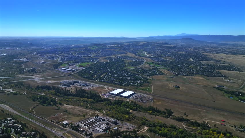Castle Rock Sedalia Pikes Peak Deckers aerial drone Colorado front range morning neighborhood homes businesses blue sky Daniels Park Castle Pines Village winter spring forward down