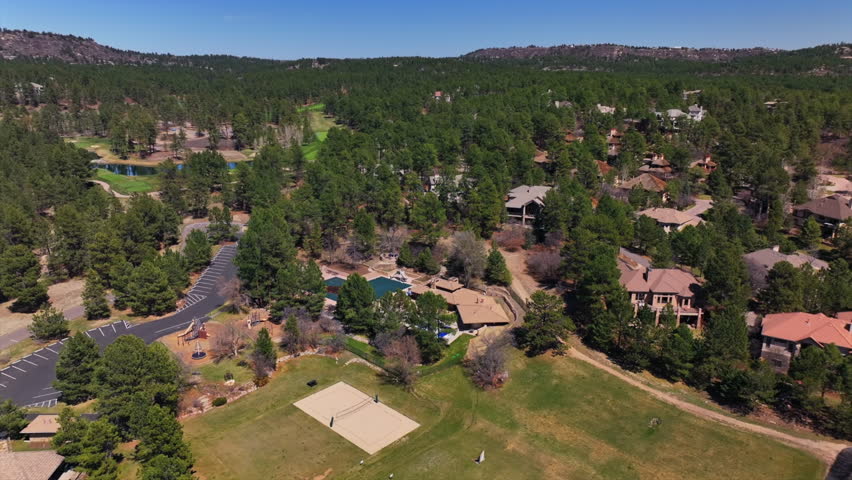 Castle Pines Village Golf Course spring aerial drone Colorado volleyball pickleball tennis courts club house front range morning gated community neighborhood homes cars roads backwards motion