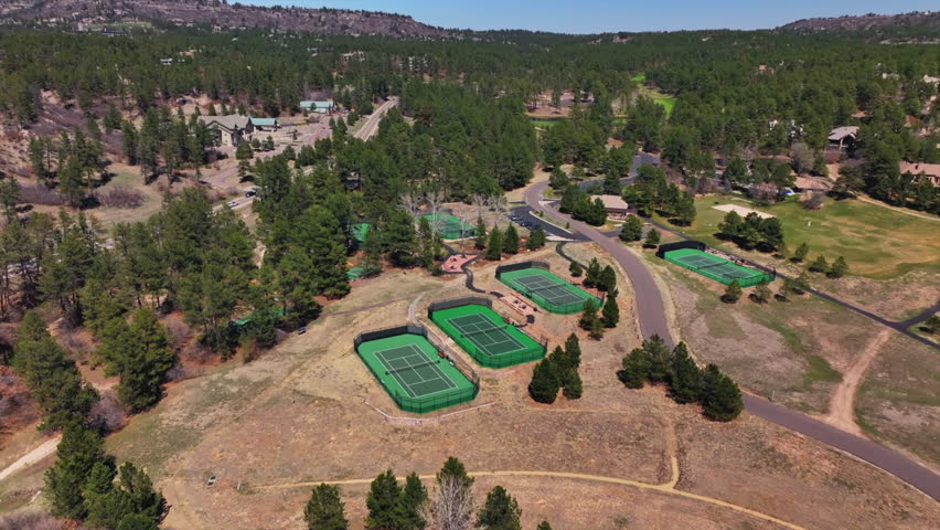 Castle Pines Village Golf Course spring aerial drone Colorado pickleball tennis courts club house front range morning gated community neighborhood homes cars roads forward pan up motion