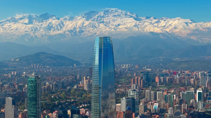 Aerial shot of the Costanera Tower with the snowy Anden Mountains in the background