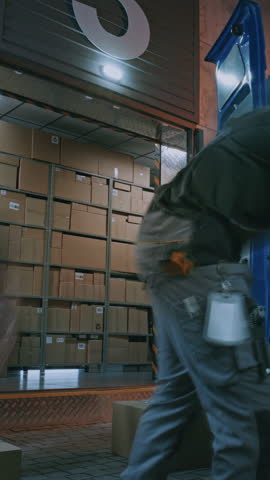 Outside of Logistics Warehouse at Night: Team of Diverse Employees Loading Delivery Truck with Cardboard Boxes with Online Orders, Goods. Express Delivery Service. Full Shot. Time Lapse. Vertical Shot