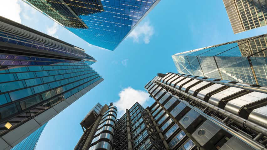 4K Footage Time lapse of Low angle view of business corporate building skyscraper in downtown district of London, United Kingdom, Time lapse and long exposure, business and finance concept
