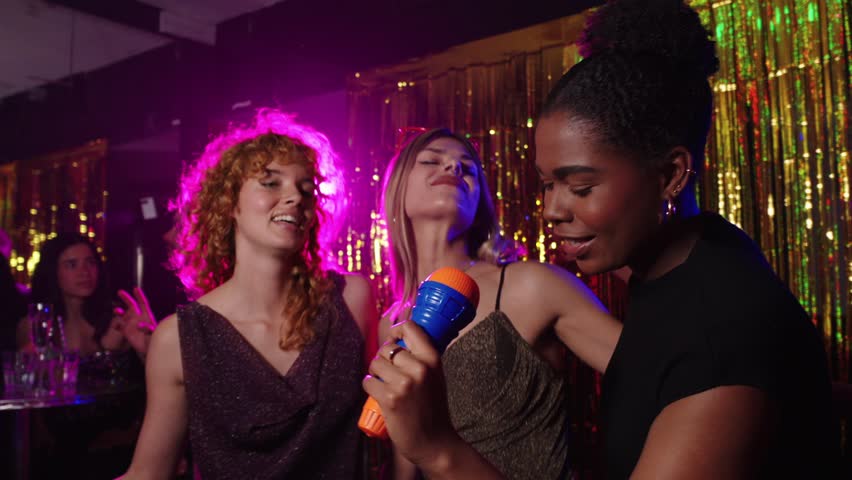 Karaoke night: friends singing in slow motion