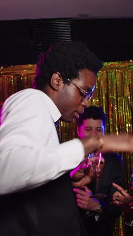 Stylish man dancing in slow motion at a party