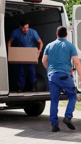 House Relocation. Men Unloading From Truck For Delivery