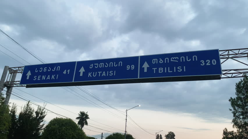 Establishing Shot of Georgian Highway Signage During an Overcast Day, Georgia
