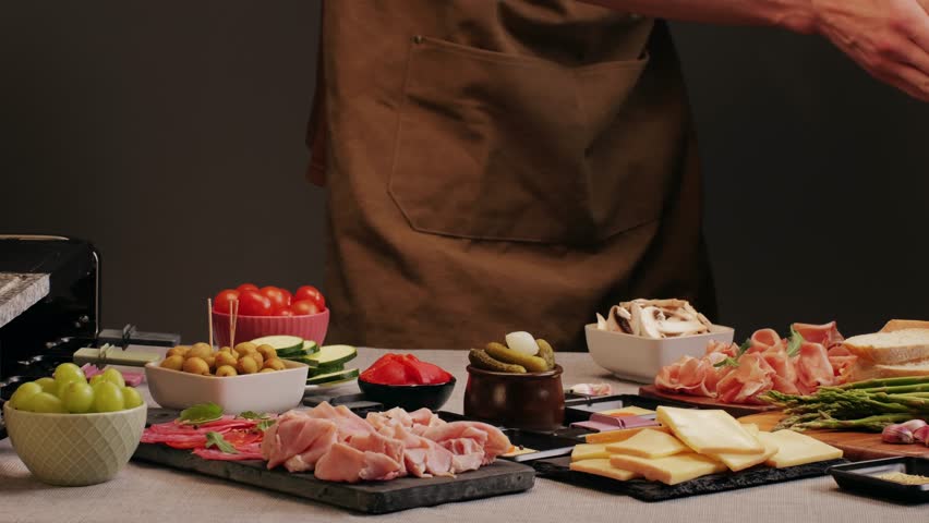 Italian or Spanish restaurant with traditional tapas food, Spanish cuisine, delicious tapas and cheese plate, bruschetta with cheese, olives dry tomatoes and tasty sandwich bar appetizer, buffet
