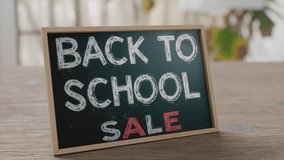 Back to school sale sign promoting discounts for students and parents in retail space - Powered by Shutterstock - Get 15% off with code: PIKWIZARD15