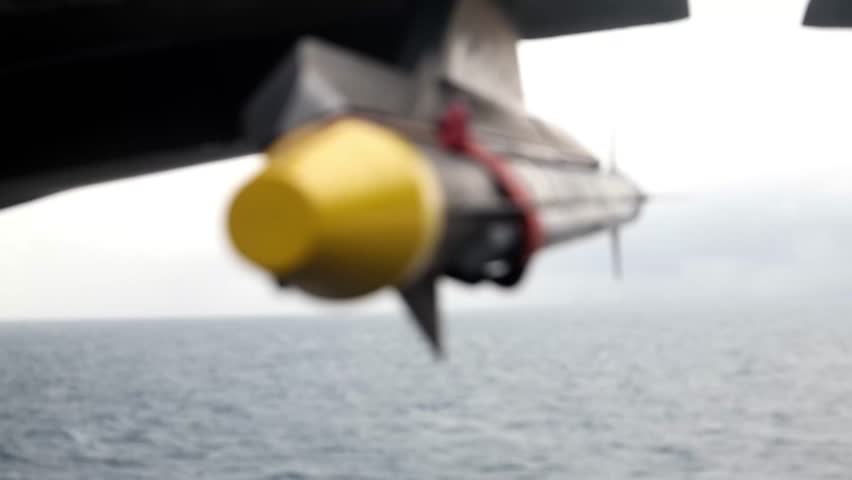 U.S. Marines with Marine Fighter Attack Squadron (VMFA) 242, load ordnance into F-35B Lightning II aircraft.