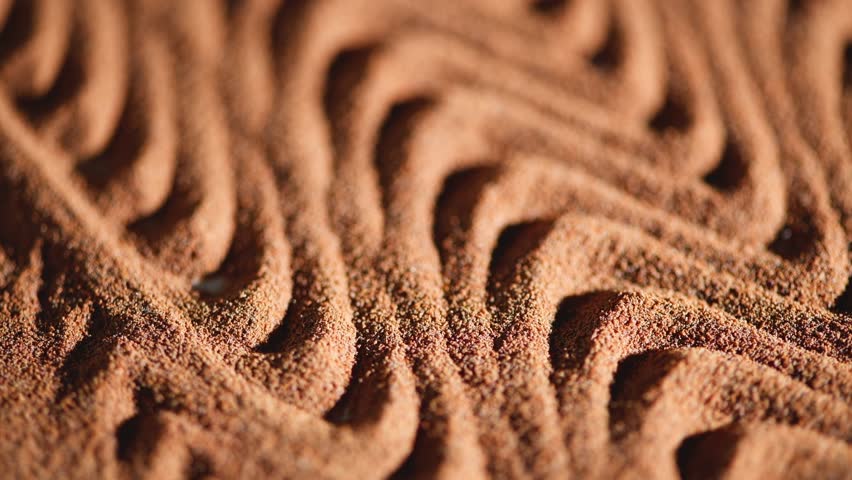 Ground chicory root forms a wavy pattern to create an interesting texture, the powder of a popular decaffeinated coffee substitute, chicory powder falls from top to bottom