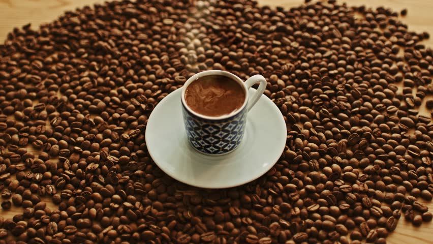 Hot Turkish Coffee in a Traditional Cup Surrounded by Coffee Beans