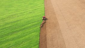 Transformation agricultural lands. Modern tractor plows bright green field, leaving behind distinct brown furrows, preparing soil for planting grain crops. Increasing yields and fertilization process - Powered by Shutterstock - Get 15% off with code: PIKWIZARD15