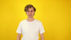 Surprised man in white t-shirt mimicking binoculars with hands, then lowering them and exclaiming WOW dynamic visual ideal for sales campaigns, discount promotions, black friday, cyber monday content - Powered by Shutterstock - Get 15% off with code: PIKWIZARD15