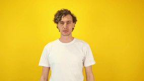 Surprised man in white t-shirt mimicking binoculars with hands, then lowering them and exclaiming WOW dynamic visual ideal for sales campaigns, discount promotions, black friday, cyber monday content - Powered by Shutterstock - Get 15% off with code: PIKWIZARD15