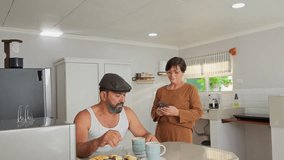 Senior hispanic couple using smartphone together in kitchen at home - Powered by Shutterstock - Get 15% off with code: PIKWIZARD15
