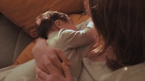 Mother cradles sleeping child in arms gently rocking baby. Infant calmly lies enveloped in nurturing embrace of mother feeling completely safe - Powered by Shutterstock - Get 15% off with code: PIKWIZARD15