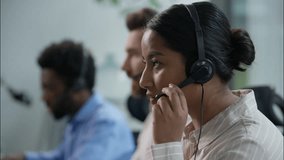 Close up diverse multiethnic business call center operators headset working helpline answering service consulting Indian businesswoman Caucasian African businessmen talking advice callcenter at office - Powered by Shutterstock - Get 15% off with code: PIKWIZARD15