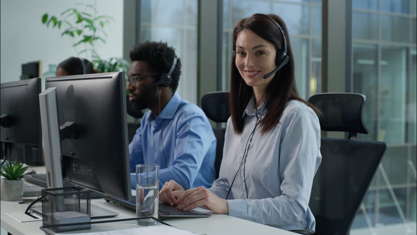 Helpline callcenter multiethnic business workers working online computer office customer service call center diverse smiling Caucasian Indian women African man in headset speak work pc helping client - Powered by Shutterstock - Get 15% off with code: PIKWIZARD15