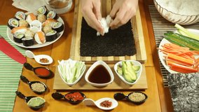 Closeup of putting Sushi rice on nori seaweed