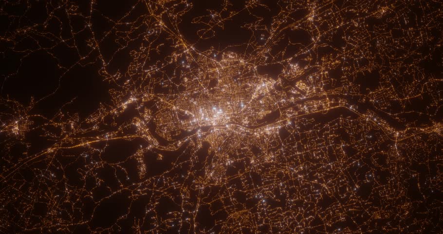 Manchester (New Hampshire, USA) aerial view at night. Top view on modern city with street lights. Camera is zooming out, rotating counterclockwise. Vertical video. The north is on the left side