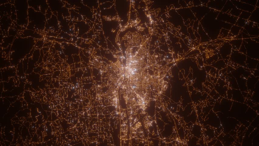 Manchester (New Hampshire, USA) aerial view at night. Top view on modern city with street lights. Camera is zooming out, rotating clockwise