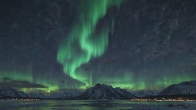A spectacular sight of the Aurora Borealis (Northern Lights) dancing with bright green intensity across the dark night sky. The dazzling curtains of green light seem to twist and stretch high in the s - Powered by Shutterstock - Get 15% off with code: PIKWIZARD15