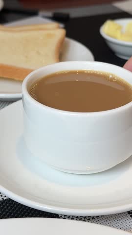 Breakfast in restaurant - fresh pastries, fruits, omelette, toast, yogurt and cup of coffee on wooden table. Good morning in hotel
