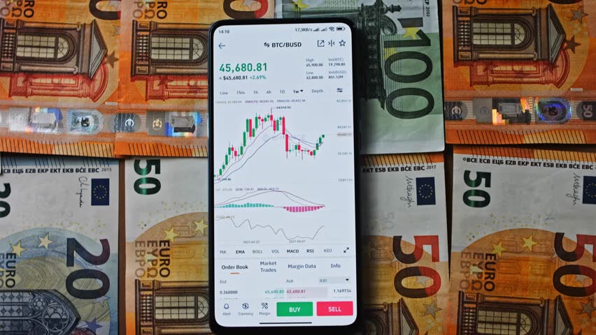 Bitcoin trading on a smartphone screen, placed over Euro bills, symbolizing the convergence of digital currencies and traditional European financial systems - Powered by Shutterstock - Get 15% off with code: PIKWIZARD15