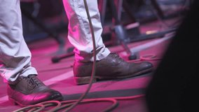 Leather clad musician's feet keeping steady rhythmic beat during energetic live performance, capturing raw musical passion from stage perspective - Powered by Shutterstock - Get 15% off with code: PIKWIZARD15