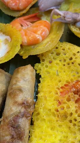 night market in Asia Thailand egg pancakes shrimp greens corn squid seafood and more stand in the shop window local interesting food on the street