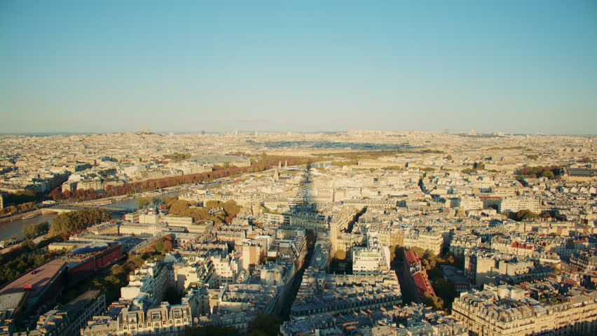 Overview of Paris from the Eiffel tower, with the tower casting a large shadow over the city. Paris cityscape with the long shadow of the Eiffel tower.