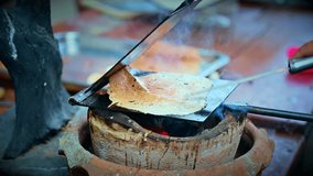 Food Series - Making Thong Muan dessert with a charcoal oven. Traditional Thai desserts. A street vendor is making crispy coconut roll. - Powered by Shutterstock - Get 15% off with code: PIKWIZARD15