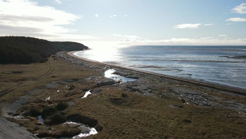 Pebble Beach full of Wooden Sticks Lying all Over the Place at Sunset of Anse-aux-Fraises, in Anticosti Island, Quebec, Canada