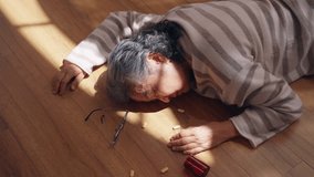 Asian senior woman suffering from heart attack or stroke symptom unconscious on the floor at home. Elderly woman get accident injured falling down and hurt. Older people hospital emergency healthcare. - Powered by Shutterstock - Get 15% off with code: PIKWIZARD15