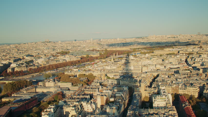 Overview of Paris from the Eiffel tower, with the tower casting a large shadow over the city. Paris cityscape with the long shadow of the Eiffel tower.