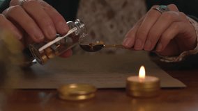 Close-up of a woman heating wax in a gold spoon on a candle, preparing to seal a letter with an antique seal. sending mail. - Powered by Shutterstock - Get 15% off with code: PIKWIZARD15