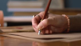 Close up of hands and handwritten letter written with antique quill pen and ink on old parchment paper. Girl writing letter. - Powered by Shutterstock - Get 15% off with code: PIKWIZARD15