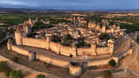 drone view of Carcassonne fortress in the southern France, aerial view of medieval city of Carcassonne, orbiting aerial view of Carcassonne medieval town at sunrise.  - Powered by Shutterstock - Get 15% off with code: PIKWIZARD15