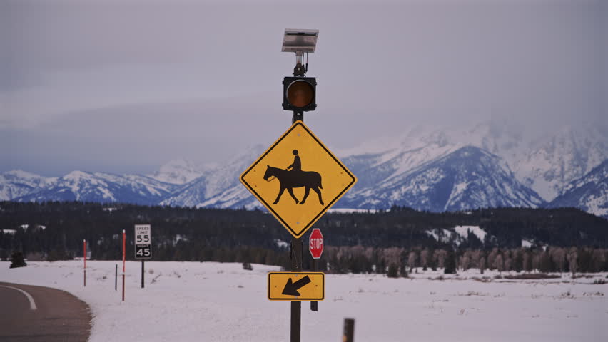 Horse Crossing Road Sign and Teton Mountains Wyoming